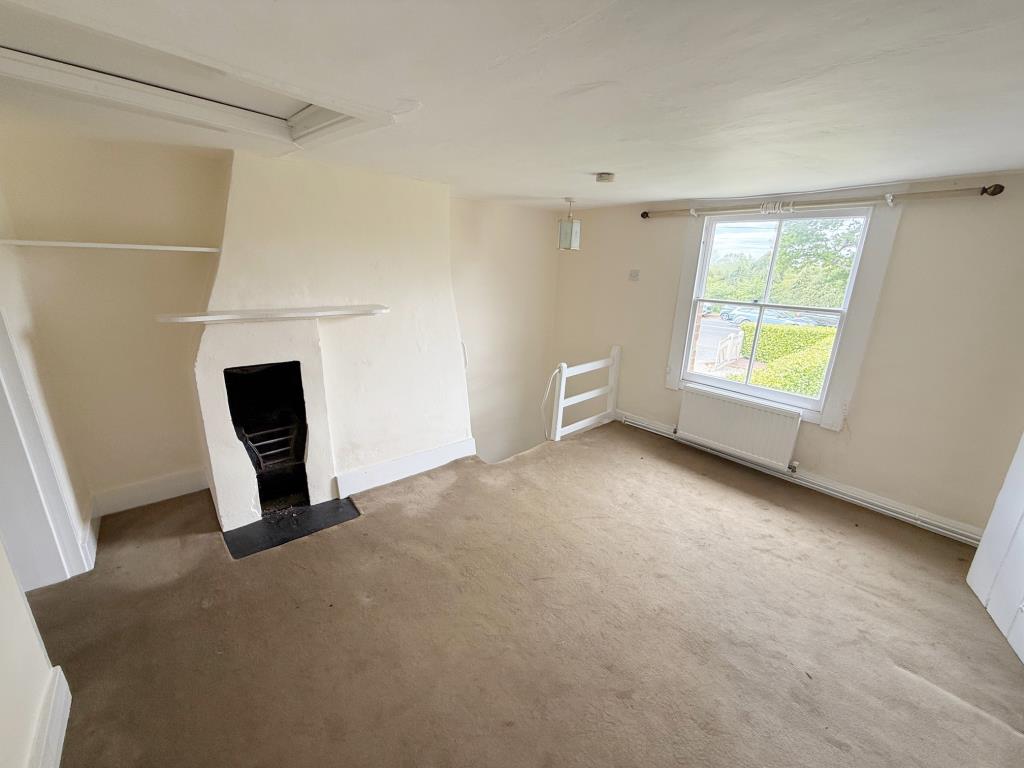 Lot: 165 - MID-TERRACE COTTAGE FOR IMPROVEMENT - Landing/Bedroom with feature fireplace and window to front